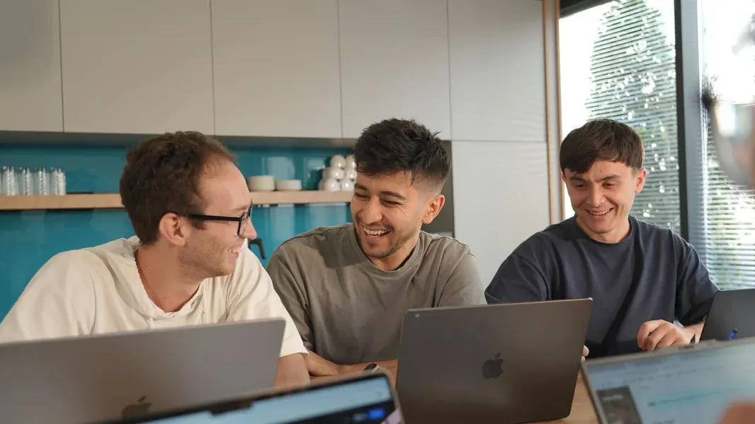 Ayan team members working together at their laptops